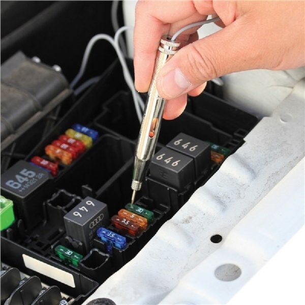 Hand using a circuit tester to check a fuse inside a car's fuse box