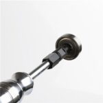 Close-up of a slide hammer bearing puller tool engaged with an inner bearing race, used for extracting tightly fitted bearings from machinery or automotive components.